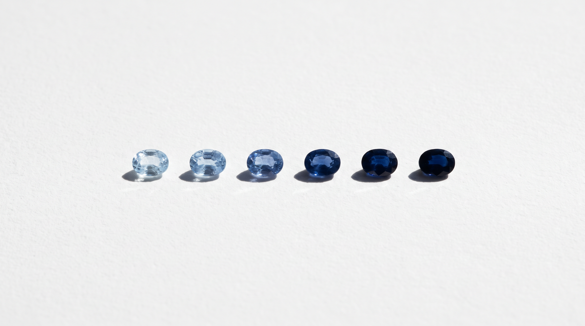 Six sapphires in a row graded from light to deep blue